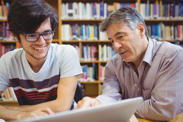 Professor assisting a student with studies - Powered by Adobe