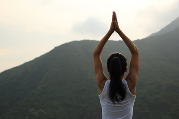 Fototapeta na wymiar young yoga woman at spring mountain peak