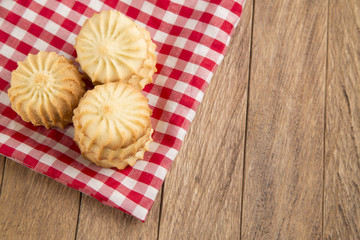 Butter cookies on a wood background.