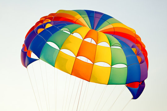 the colorful stripes of parachute in the sky