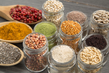 Variety of spices and grains on wooden background