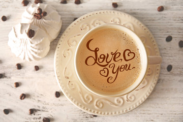 Cup of coffee with words Love You, top view