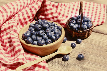 Fresh blueberries on wooden table. Retro style