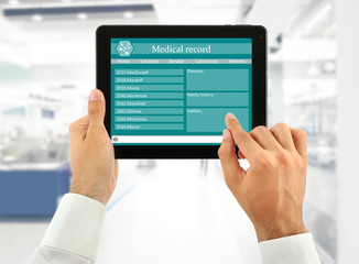 Medical tablet in doctor hands on light background
