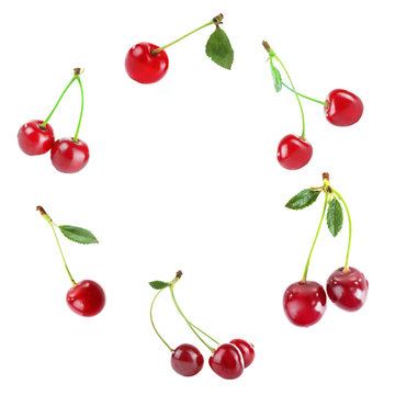 Round frame made of cherries isolated on white