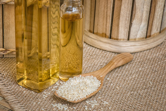 Sesame seed on wooden spoon with sesame oil