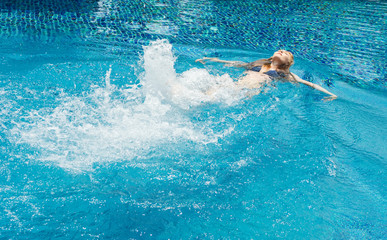 Young caucasian woman swimming