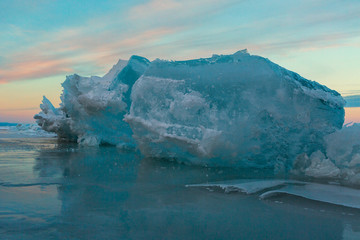 Huge blocks of ice at sunset sky background.