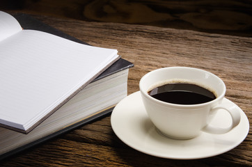 Cup of coffee with books and note book