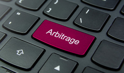 Business Concept: Close-up the Arbitrage button on the keyboard and have Magenta color button...