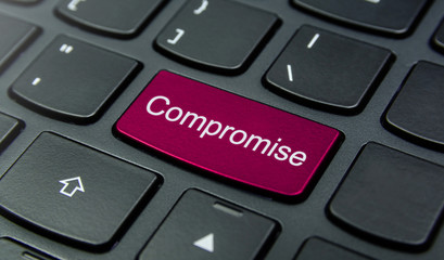 Business Concept: Close-up the Compromise button on the keyboard and have Magenta color button isolate black keyboard