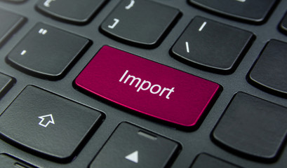 Business Concept: Close-up the Import button on the keyboard and have Magenta color button isolate black keyboard