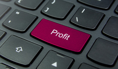 Business Concept: Close-up the Profit button on the keyboard and have Magenta color button isolate black keyboard