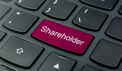 Business Concept: Close-up the Shareholder button on the keyboard and have Magenta color button isolate black keyboard
