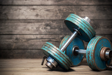 Vintage dumbbells on the wooden floor.