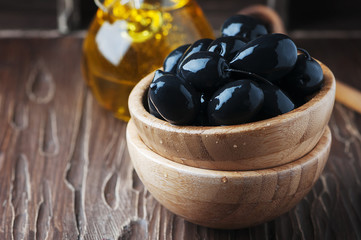 Greek black olive and oil on the wooden table