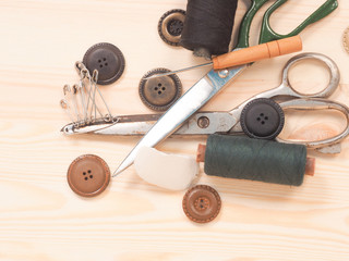 Sewing accessories in a wood background. sewing concept