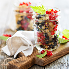 Fresh assorted currants in jars