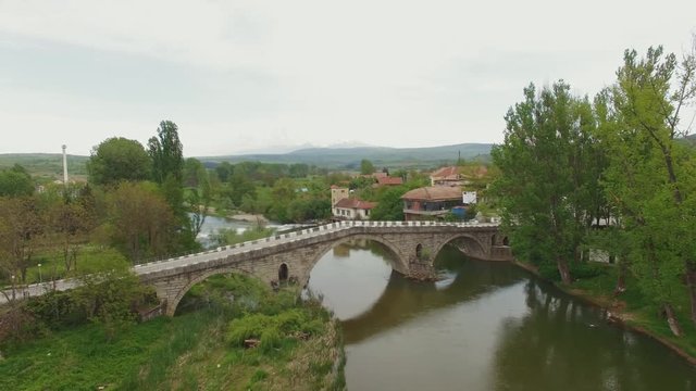Aerial video over Struma river at spring / Old stone brodge from 1450 year