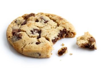 Single light chocolate chip cookie, bite missing with crumbs, is