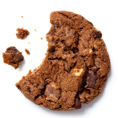 Dark brown chocolate chip cookie, bite missing with crumbs from - obrazy, fototapety, plakaty