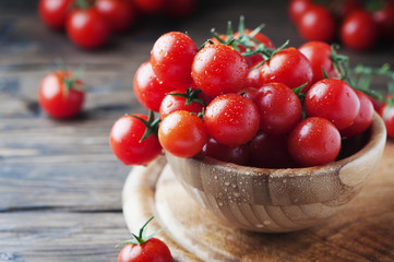 Fototapeta na wymiar Red sweet tomatoes cherry on the wooden table