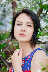 Beautiful woman among blossoming cherry  tree. girl among the blooming trees