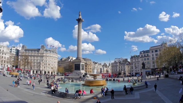 Fish eye view of Trafalgar square in London with fountains, admiral Nelson column, car traffic and people