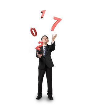 Businessman catching throwing 2017 red words