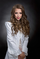 Naklejka premium Beautiful woman with brown hair in a white jacket