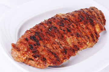 Pork steak on white plate