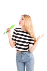 Girl hold hairbrush as microphone isolated