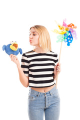 Girl play with toys and colour windmill isolated
