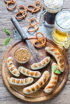 Grilled sausages with pretzels and mugs of beer