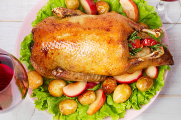 Roast duck with potato, apples, salad, thyme and rosemary. View From Above, Top Studio Shot