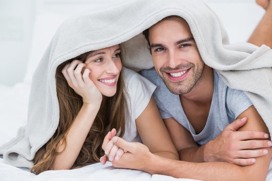 Happy Couple Enjoying Under Blanket 