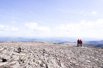 Two girl on top of a mountain looking the panorama, Pen Y Fan - obrazy, fototapety, plakaty