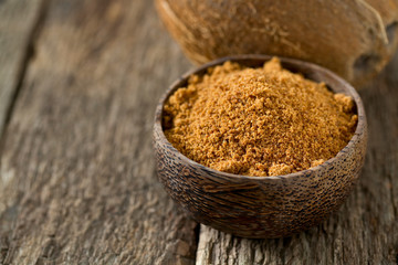 coconut palm sugar on wooden surface