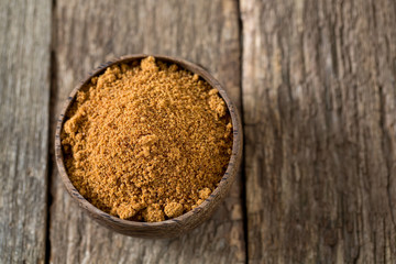 coconut palm sugar on wooden surface