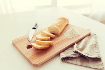 close up of white bread or baguette and knife