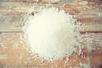 close up of white salt heap on wooden table