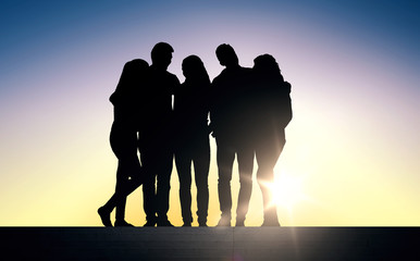 silhouettes of friends sitting on stairs over sun