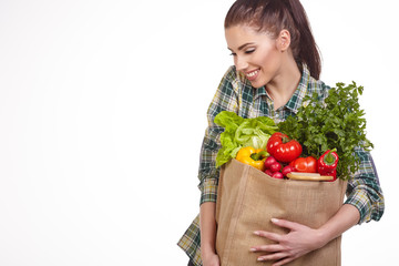 Isolated woman holding a shopping bag full of vegetables