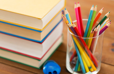 Fototapeta premium close up of crayons or color pencils and books