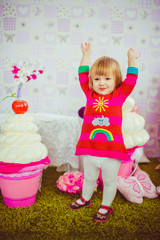 Little girl and toy pink cupcake