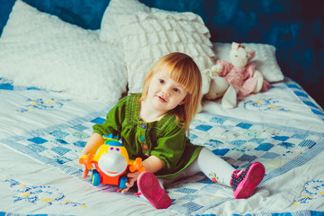 Lovely little girl holds her colorful toy