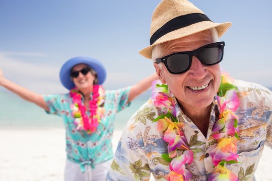 Happy senior couple having fun together on the beach