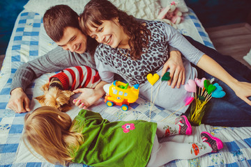 Bright photo of the happy young family