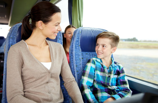 happy family riding in travel bus