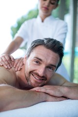 Obraz premium Man receiving back massage from masseur